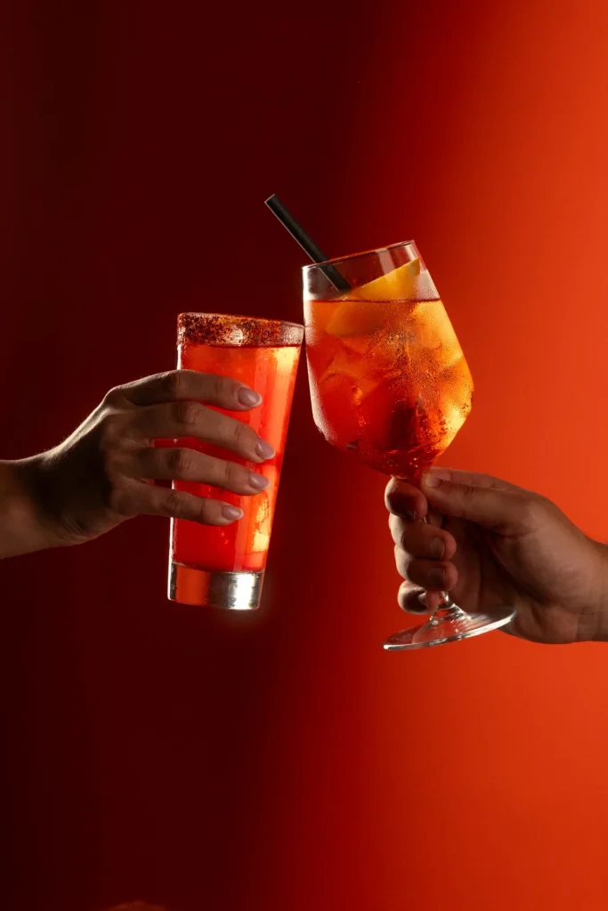 Two guests toasting with Italian-inspired signature cocktails at Matto in St George’s Bay