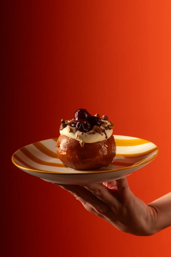Maritozzo filled with cream and topped with cherries and pistachio at Matto in St George’s Bay