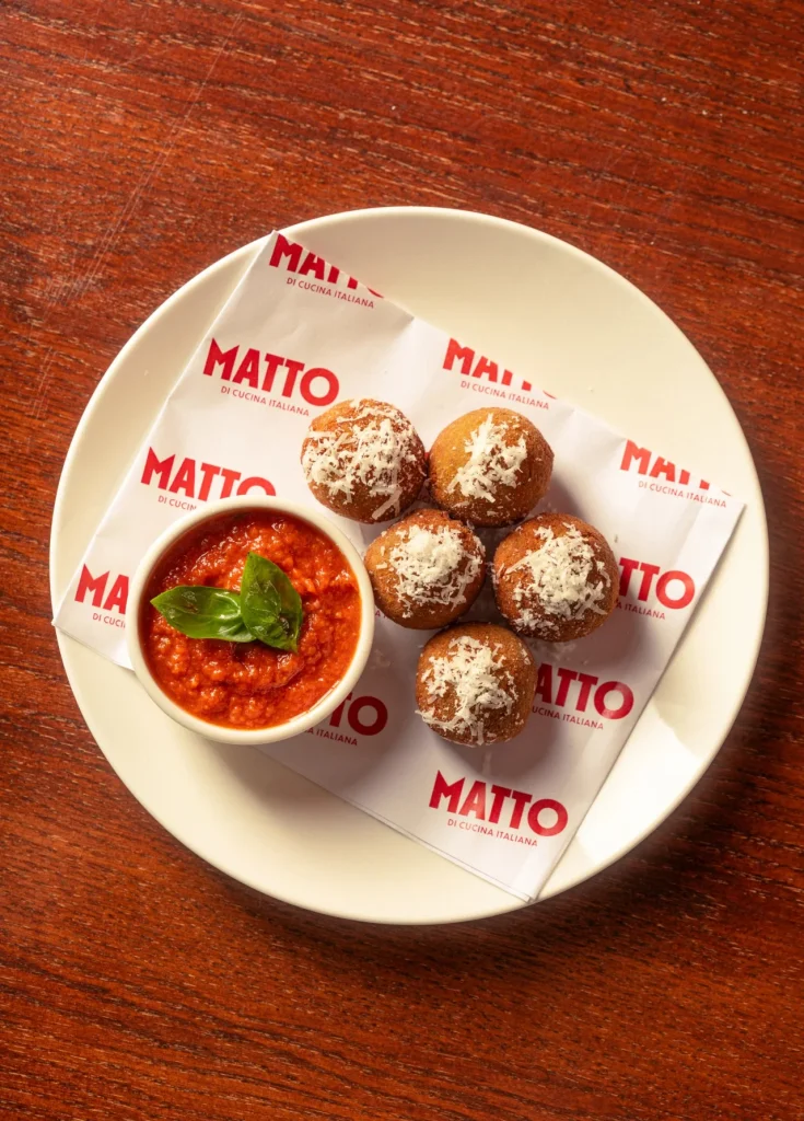 Sicilian arancini with spicy tomato sauce, basil and grated cheese at Matto in St George’s Bay